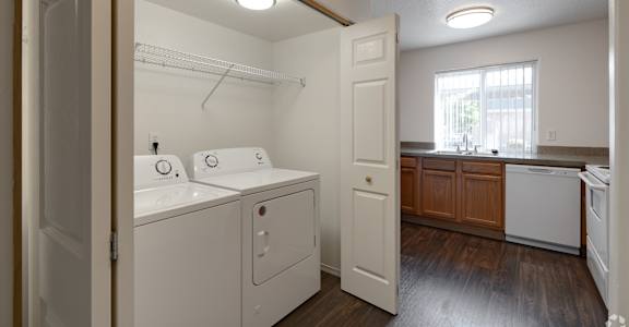 A small laundry room with a washer and dryer.