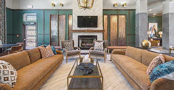 A living room with a fireplace and a large couch.