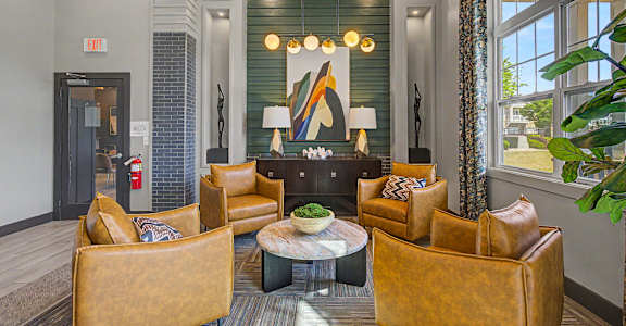 A living room with a fireplace and a large painting above it.