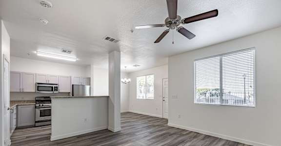 A spacious kitchen with a refrigerator, microwave, and oven.