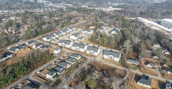 An aerial view of a residential area with houses and roads.