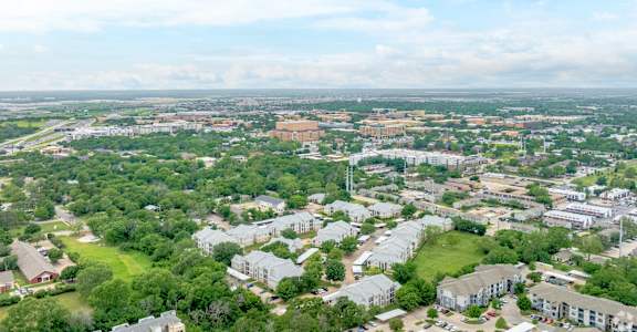 an aerial view of a city with houses and trees
