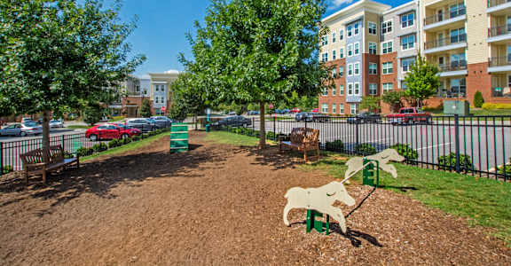 A playground with a slide and a horse-shaped swing set.