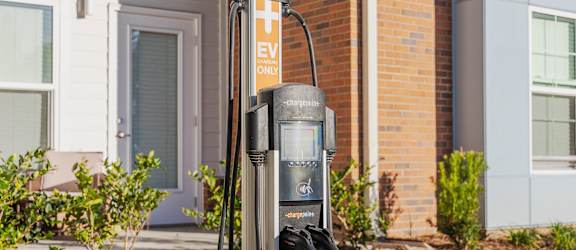 a gas pump in front of a brick building
