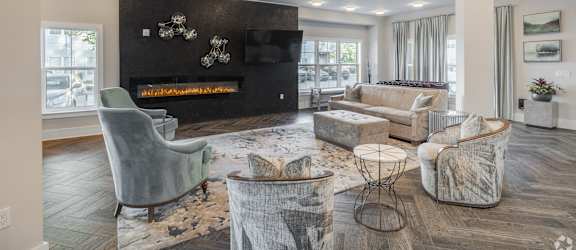 a living room with couches and chairs and a fireplace