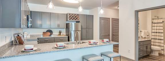A kitchen with a bar stool and a counter.