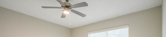 an empty room with a ceiling fan and a window at Carlton Park Apartment Homes, Flowood, MS, 39232