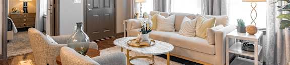 a living room with a couch and chairs and a ceiling fan at Kingston Crossing Apartment Homes, Bossier City, LA