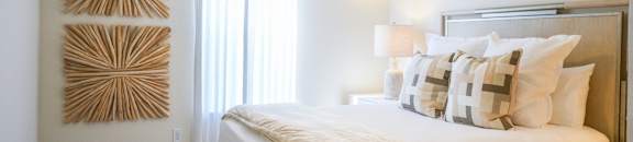 a bedroom with a large bed and a ceiling fan at The Vineyard at Castlewoods Apartment Homes in Brandon, MS 39047