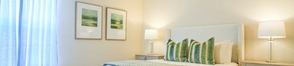 a bedroom with a bed and a ceiling fan at The Vineyard at Castlewoods Apartment Homes in Mississippi 39047