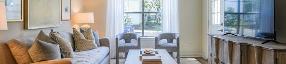 a living room with a couch and a coffee table at The Vineyard at Castlewoods Apartment Homes in Brandon, Mississippi 39047