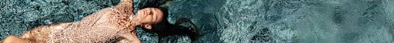 a woman swimming in a body of water