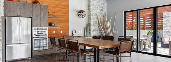 A kitchen with white cabinets and a wooden island.