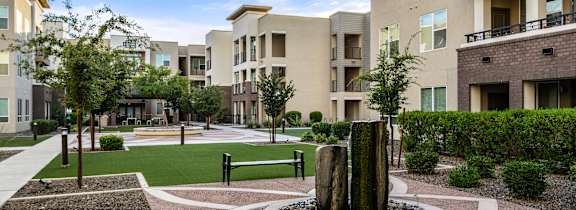 A courtyard with a fountain in the middle of it.