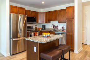 a kitchen with stainless steel appliances and a granite counter top