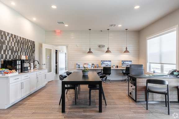 A modern kitchen with a dining table and chairs.