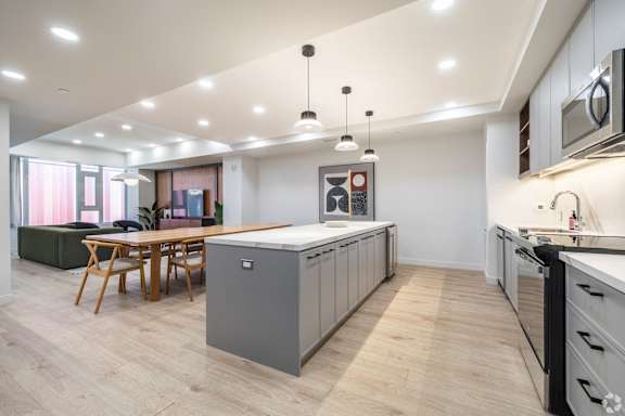 A modern kitchen with a dining table and chairs.