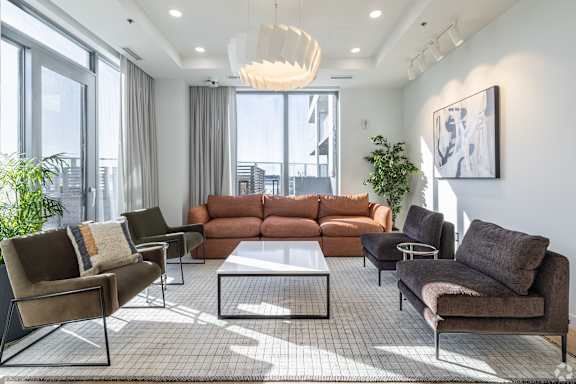 A modern living room with a large sectional sofa and a coffee table.