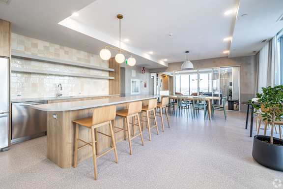 A modern kitchen with a long island and bar stools.