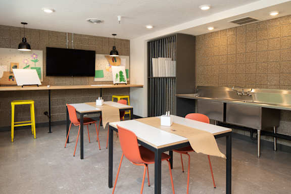 A modern dining area with a long table and chairs.