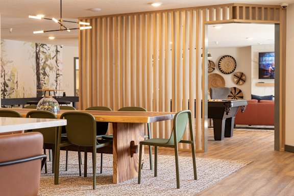 A room with a wooden table and chairs.