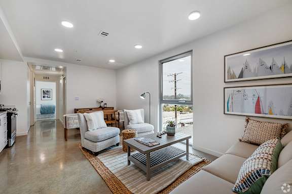 A modern living room with a large window and a view of the outdoors.
