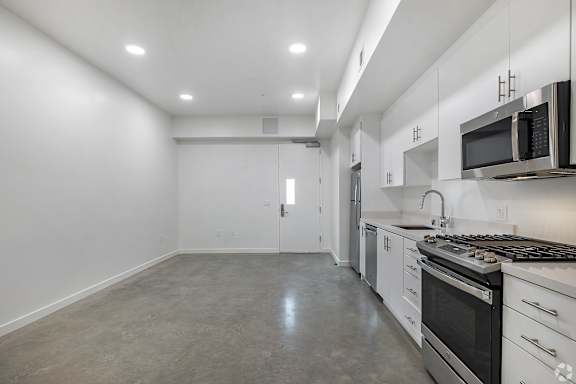 A kitchen with white cabinets and stainless steel appliances.