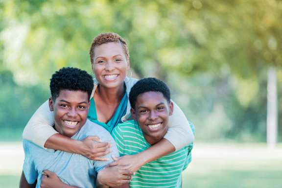 three young people hugging each other with their arms around each other