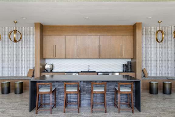 A modern kitchen with wooden cabinets and a dark countertop.