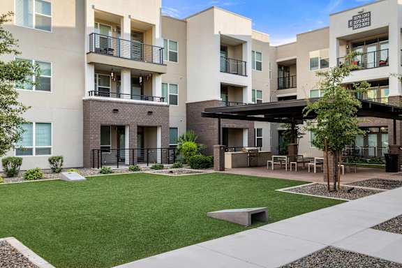 Apartment complex with a green lawn in front.
