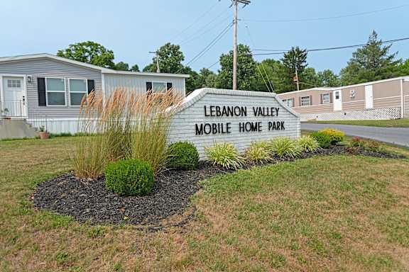 A sign that says Lebanon Valley Mobile Home Park in front of some homes.