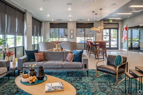 A living room with a grey couch and a blue coffee table.