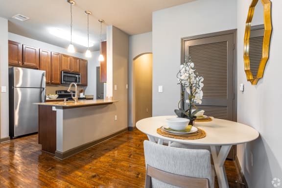 a kitchen with a sink and a living room  at Kingston Crossing Apartment Homes, Bossier City, Louisiana