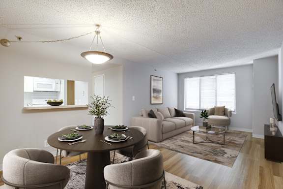 A dining room with a round table and chairs.