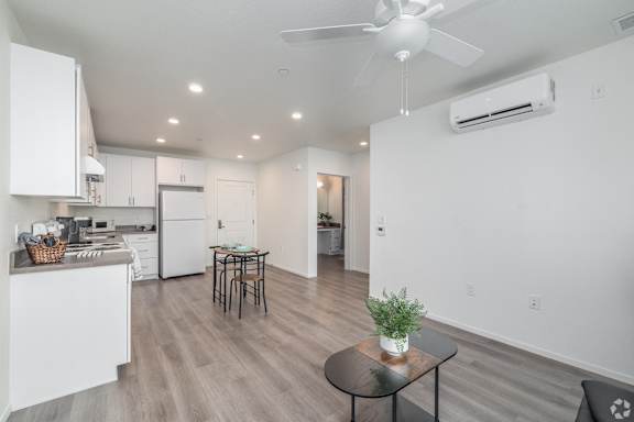 A modern kitchen with a dining table and chairs.