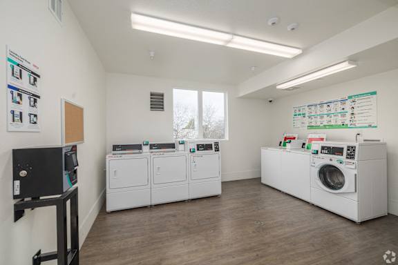 A laundry room with washers and dryers.