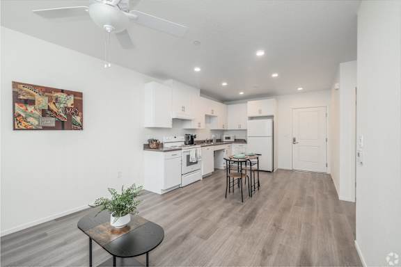 A modern kitchen with a dining table and chairs.