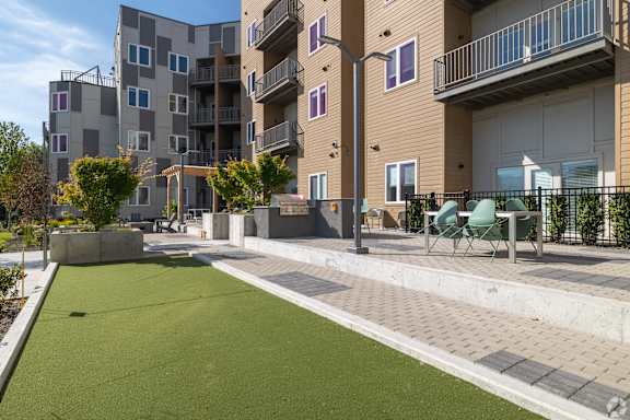 Apartment complex with a green lawn in front.
