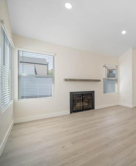 A modern kitchen with a dining area and a view of the balcony. at Hamilton Courtyard Apartments, California, 92627