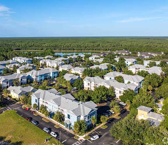 A bird's eye view of a residential area with houses and cars.