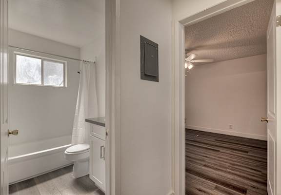 an empty bathroom with a toilet and a shower in it