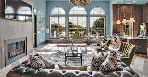 a living room filled with furniture and a large window