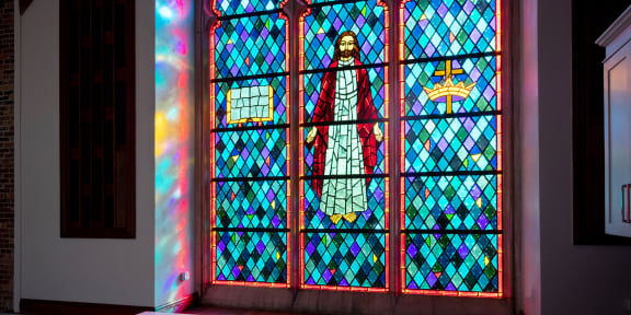 a stained glass window in the kitchen of a church