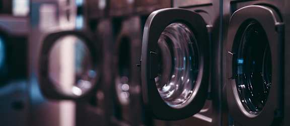 a row of washing machines in a laundromat