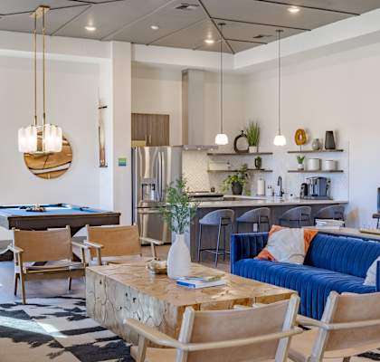A modern living room with a blue couch and wooden chairs at Springview by Vintage, Reno, NV