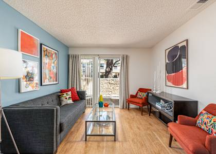 a living room with a couch and a glass coffee table