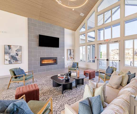 a large living room with a couch and chairs and a fireplace at Sycamore at Tyvola, NC