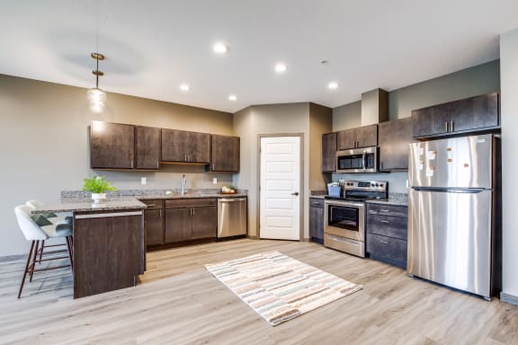 a kitchen with stainless steel appliances and wooden cabinets