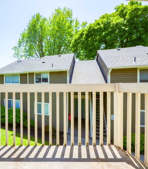 a white wooden fence in front of a house
