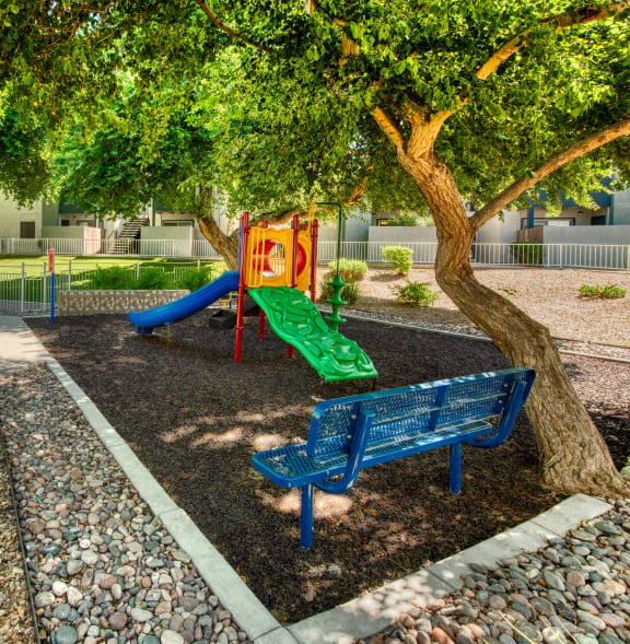 a playground with a blue bench and a colorful slide at Connect on Northern, Arizona, 85301